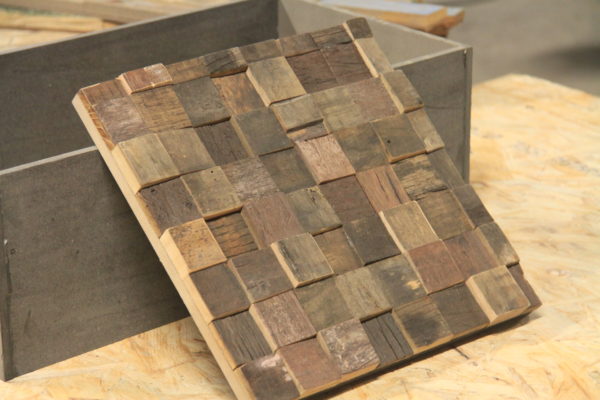 Old barrels design with reclaimed wood squares. They're organized one after the other, in a chess board like pattern.