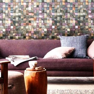 An old barrels environment with a purple couch and other furniture. Behind, there's a wood panel that was created from antique oak barrels.