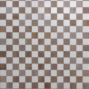 A wood surface that resembles a chess board. The white squares are made from paitned wood, as the other squares are made from reclaimed timber. Each color is organized in a distributed pattern.