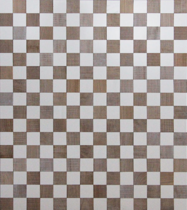 A wood surface that resembles a chess board. The white squares are made from paitned wood, as the other squares are made from reclaimed timber. Each color is organized in a distributed pattern.