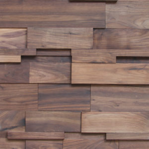 This wood panel is composed of small wood strips in various sizes, some higher than the others. Each wood strip has a wood veneer covering that makes each piece look like natural wood with medium tones.